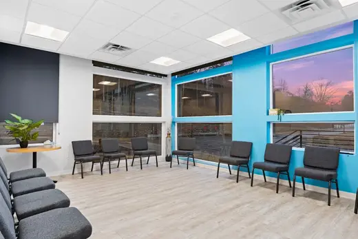 Bright waiting area with large windows at a detox center in Charlotte.