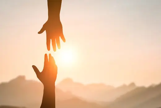 Outstretched hands reaching towards the sun at Queen City Treatment Center, a detox center in Charlotte.