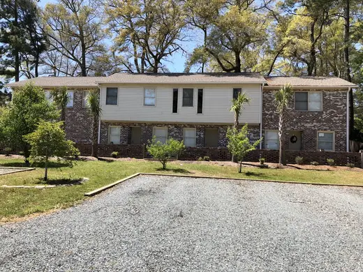 Spacious exterior with landscaped yard at Beach House Recovery, a sober living home in Charlotte.