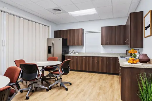 Modern kitchen with dining area in a treatment center in Charlotte.